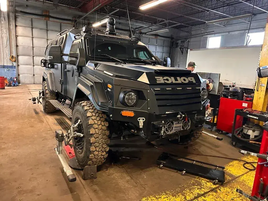 Heavy-duty police vehicle in the D&A Mechanics garage for inspection